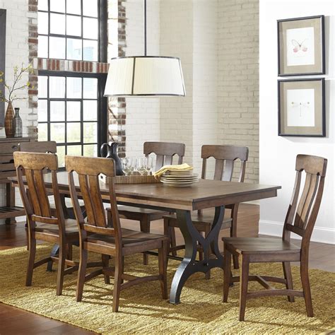 Intercon furniture - Sullivan Trestle Dining Table. The Sullivan Dining Collection features a large dining and gathering table, side chair and stool with comfortable cushion seating, dining and gathering bench for added seating and a stylish server. Features. Burnished Clay Finish. Solid Acacia and Select Hardwood. 22" Self Storing Leaf. Metal table glides included. 